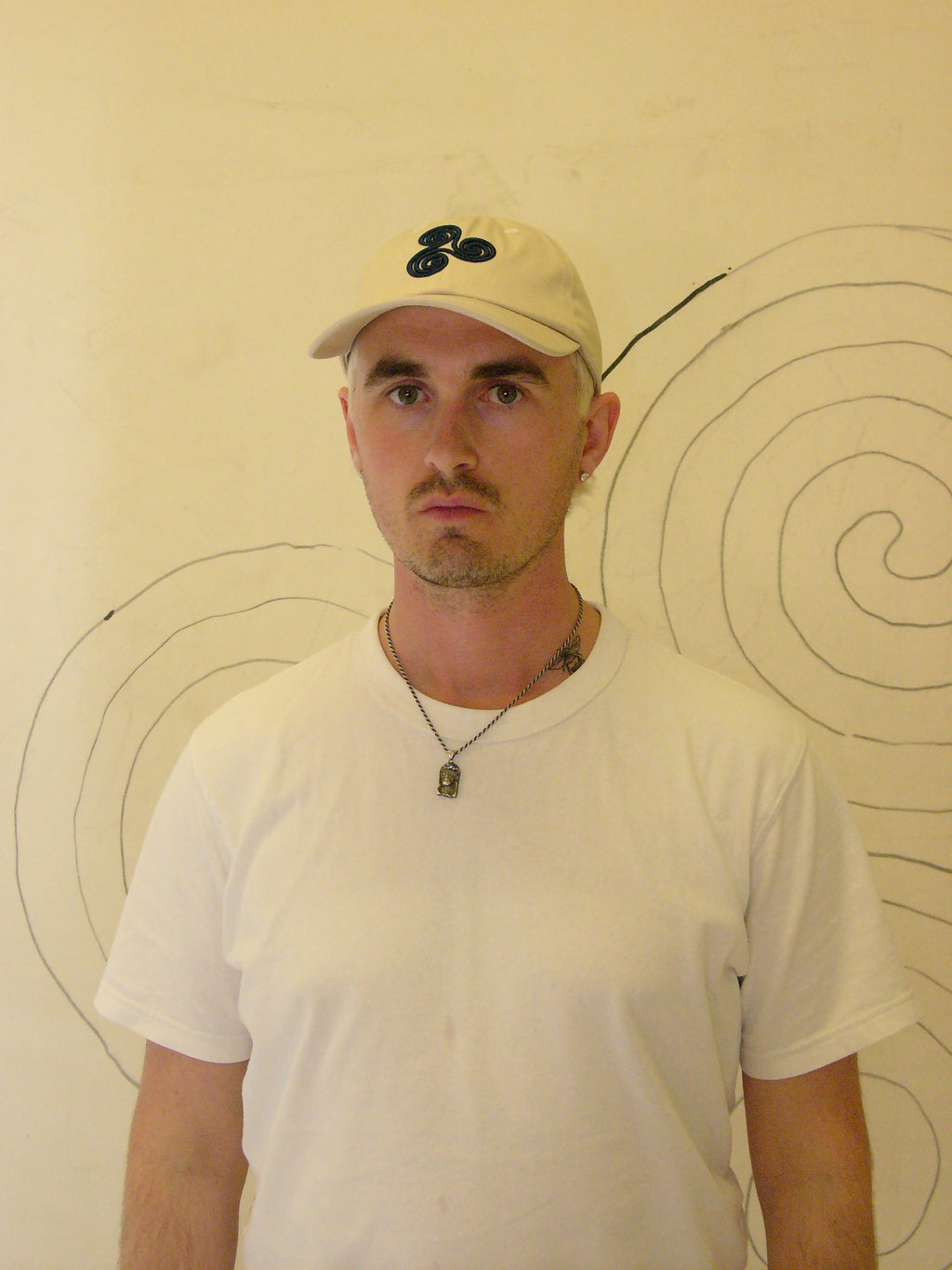Beige Triskelion Derhúfa